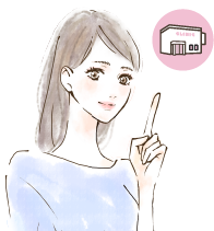 クリニックを指さしている女性